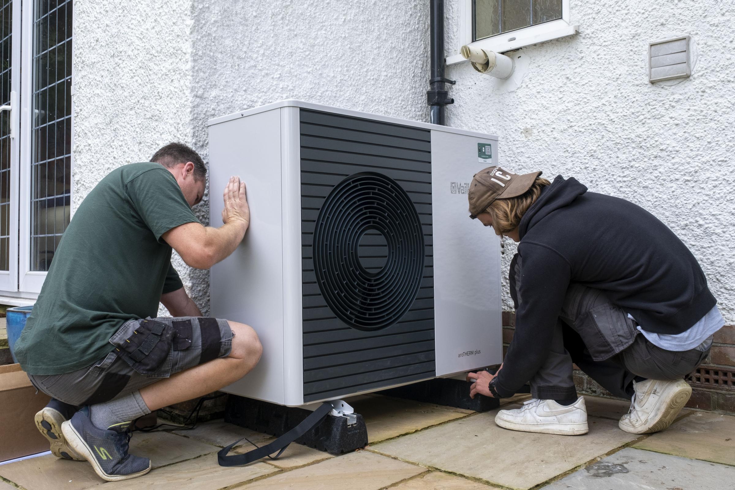 Air source heat pump installers from Solaris Energy installing a Vaillant Arotherm plus 7kw air source heat pump unit into a 1930s built house in Folkestone, United Kingdom on the 20th of September 2021. With gas prices increasing and the increasing