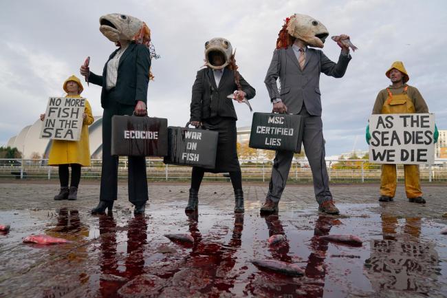 Three performers with bleeding Fishhead masks and pinstripe suits during a demonstration in Glasgow by Ocean Rebellion against the Marine Stewardship Council (MSC) . Picture date: Thursday November 4, 2021.