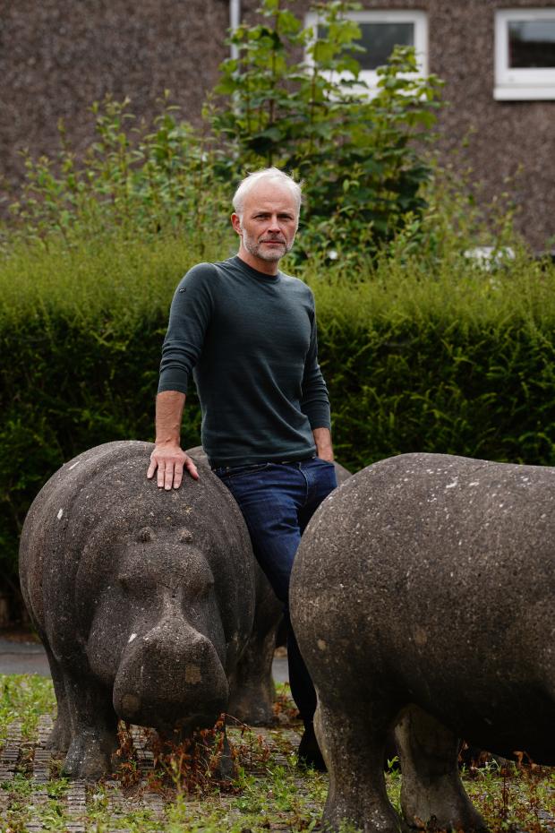 HeraldScotland: Mark Bonnar in Glenrothes with one of the concrete hippos made by his dad Stan in the 1970s. Picture: BBC/Objective Media