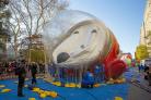A crew inflates the Astronaut Snoopy character helium balloon in New York City on Wednesday, Nov. 24, 2021, ahead of Thursday's annual Macy's Thanksgiving Day Parade. (AP Photo/Ted Shaffrey)