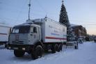 A Russian Emergency Ministry truck is parked at the Listvyazhnaya mine, right, near Belovo, in the Kemerovo region of southwestern Siberia, Russia, Friday, Nov. 26, 2021. A devastating explosion in the Siberian coal mine Thursday left dozens of miners