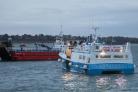 French fishing boats block the entrance to the port of Saint-Malo, western France, Friday, Nov. 26, 2021. French fishing crews are threatening to block French ports and traffic under the English Channel on Friday to disrupt the flow of goods to the U.K.,