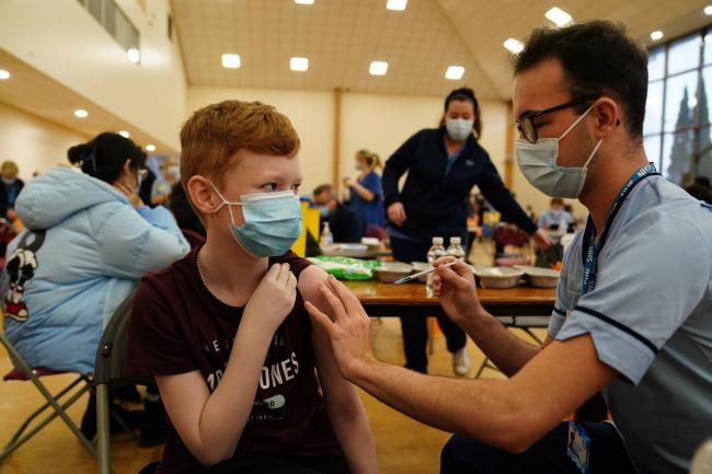 Dean Morrison, 13, receives his Covid-19 vaccine from student nurse Anthony McLaughlin during a vaccination clinic at the Glasgow Central Mosque. Youngsters aged between 12 and 15 are being urged to get their second coronavirus vaccine before heading
