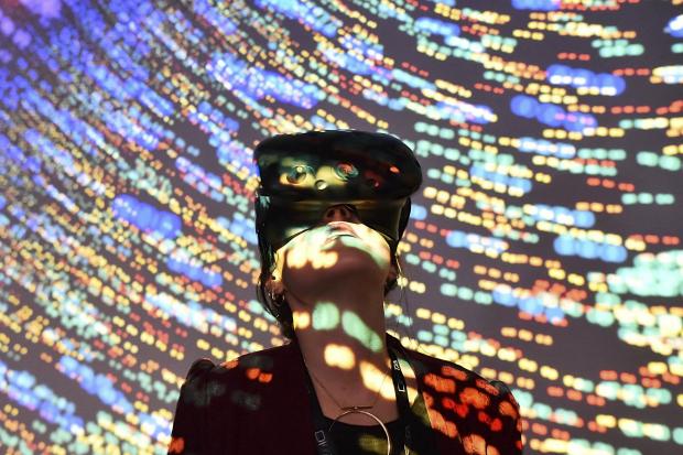 HeraldScotland: A visitor uses a virtual reality headset during a technology show in France in 2018. (Jean-Francois Monier/Agence France-Presse — Getty Images)