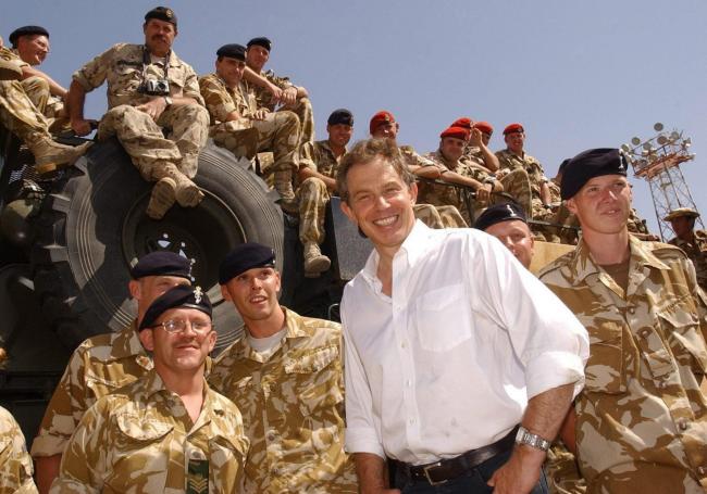 File photo dated 29/05/03 of Tony Blair meeting troops in the port of Umm Qasr. The former Prime Minister would like to be remembered for transforming Britain's schools and bringing peace to Northern Ireland, but for many his premiership was defined