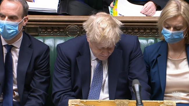 Boris Johnson, head bowed, endures the storm at Prime Minister's Questions yesterday