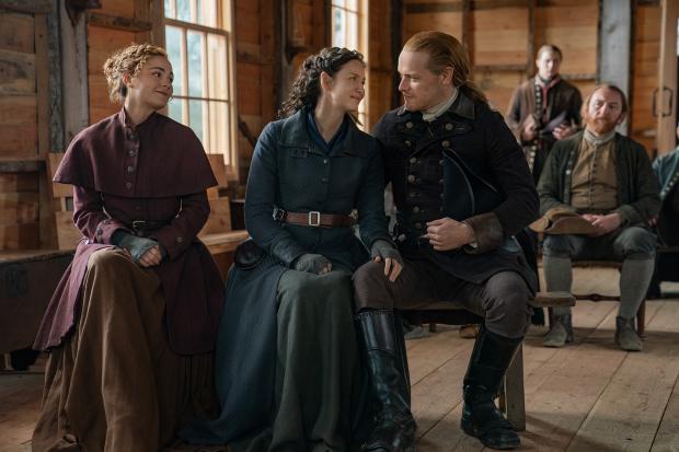HeraldScotland: Sam Heughan with Outlander co-stars Sophie Skelton and Caitriona Balfe. Picture: Robert Wilson/Starz
