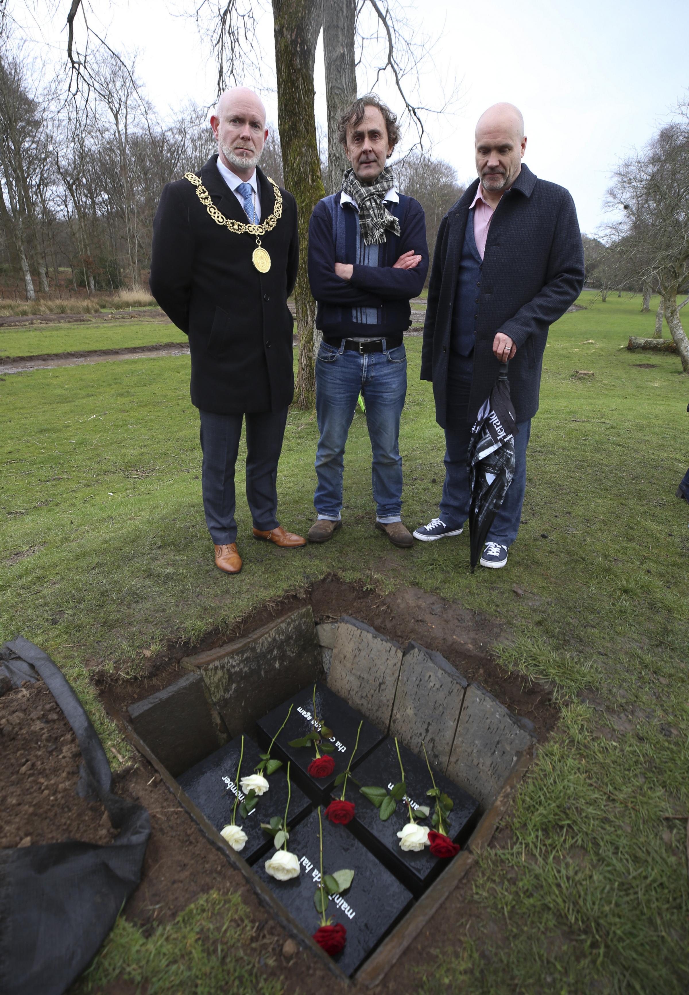 Boxes with I remember messages buried in Pollok Country Park. From left, Lord Provost of Glasgow Philip Braat, artist Alec Finlay and Donald Martin, editor of The Herald. Photo by Gordon Terris.