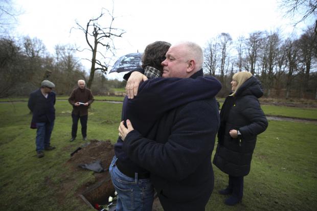 HeraldScotland: A series of boxes with 'I remember' messages were buried at Scotland's Covid memorial. Artist Alec Finlay with Peter McMahon of Covid 19 Families Scotland. Photo by Gordon Terris.