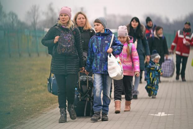 HeraldScotland: People crossing the border point from Ukraine into Medyka, Poland. Photo via PA.