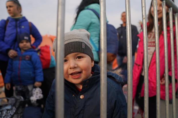 HeraldScotland: People who have crossed the border point from Ukraine into Medyka, Poland, wait to board a bus. Photo via PA/Victoria Jones.