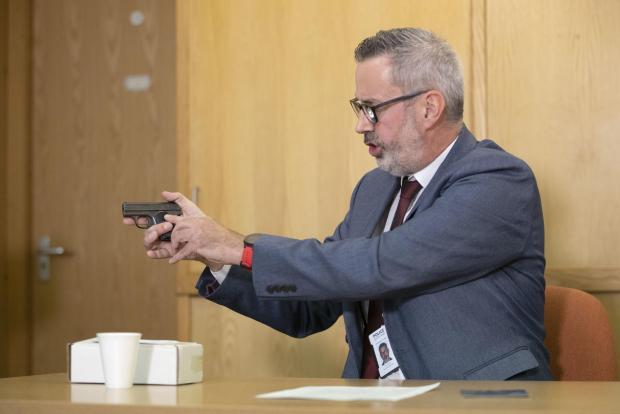 HeraldScotland: Detective Inspector Gary Winter holds a replica of the gun, used in the killing of Alistair Wilson, during an appeal in 2020.