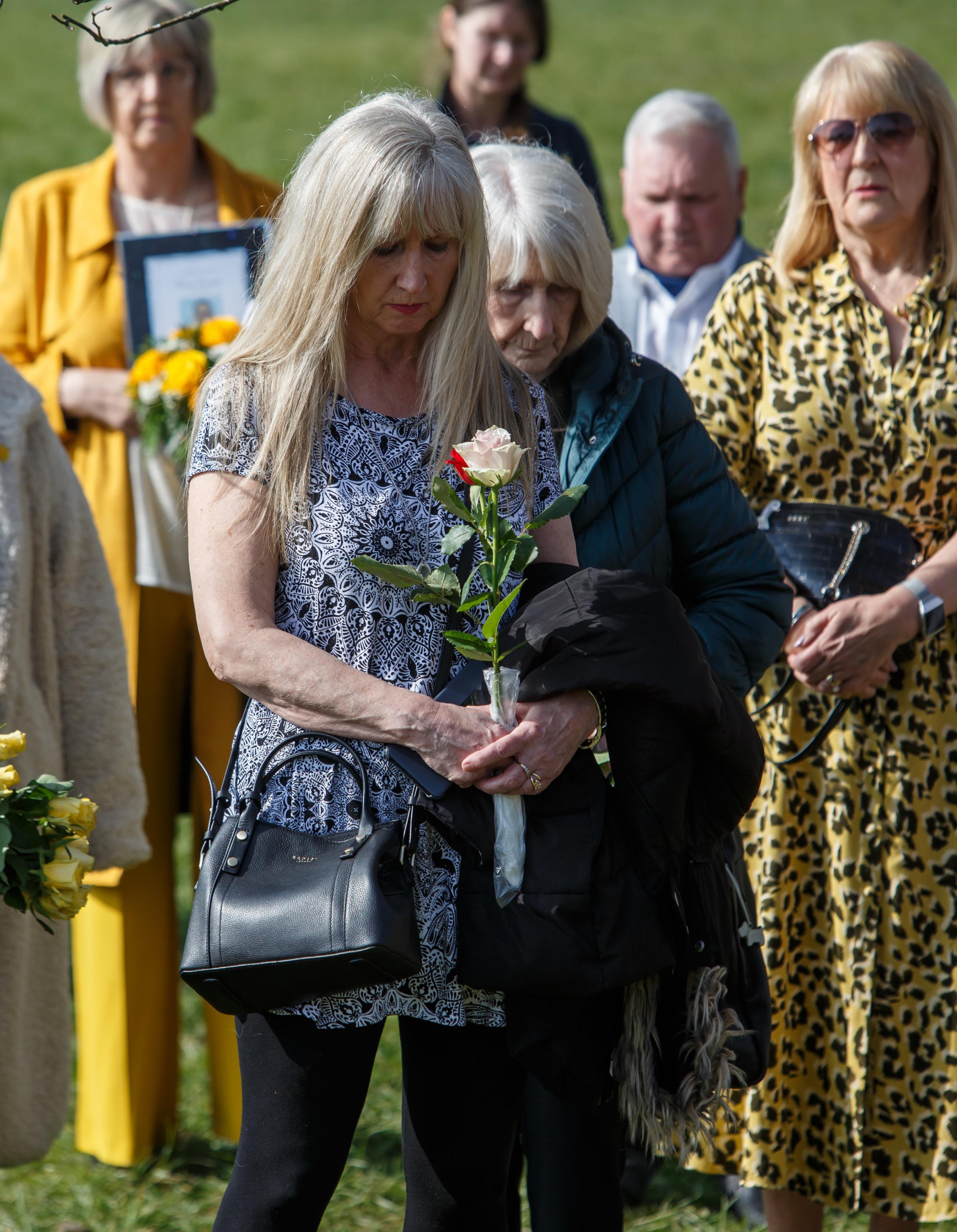People pictured during a minutes silence for those lost to Covid at Riverside Grove in Pollok Country Park in Glasgow. Photograph by Colin Mearns.