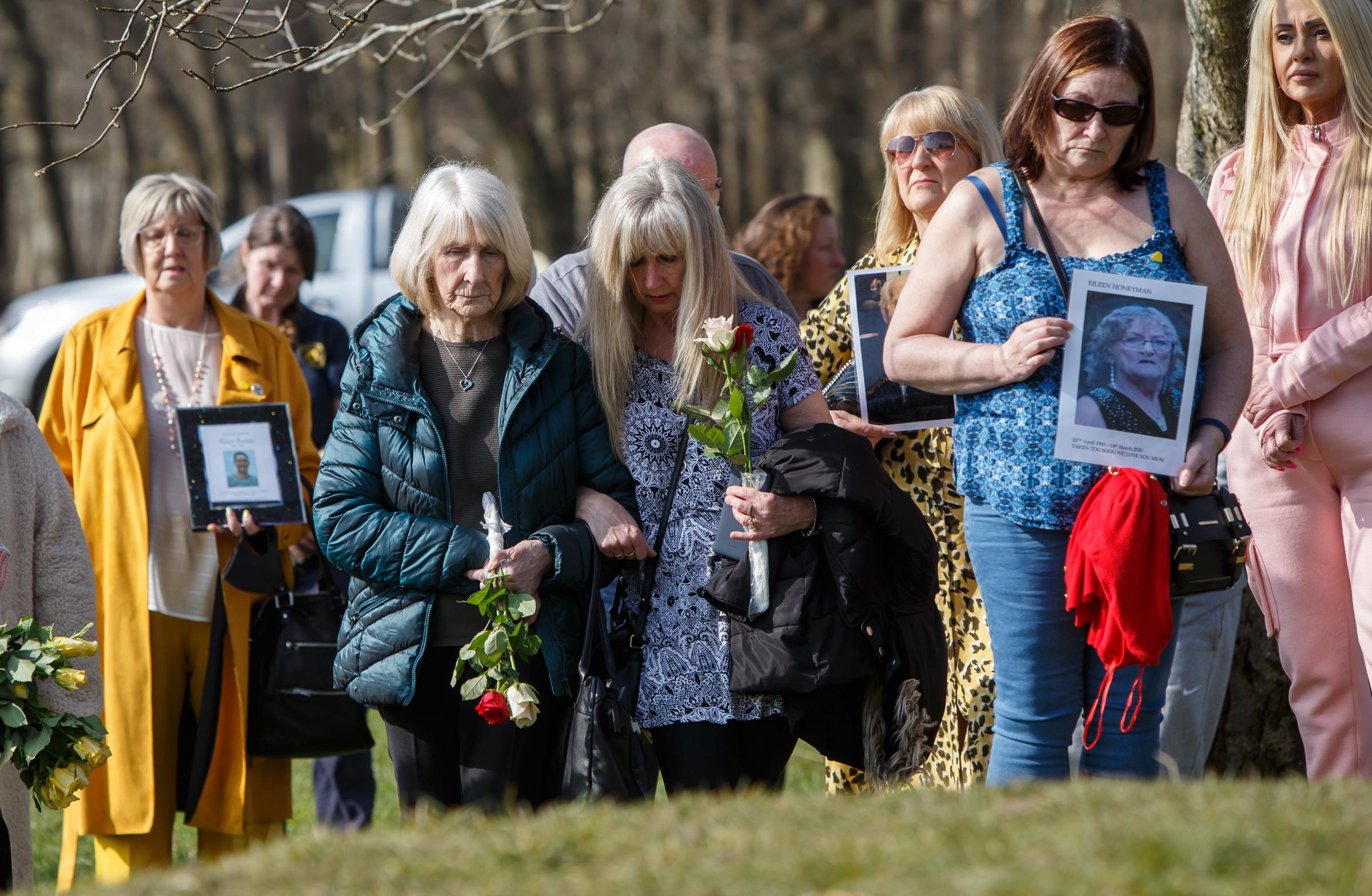 People pictured during a minutes silence for those lost to Covid at Riverside Grove in Pollok Country Park in Glasgow. The Heralds covid memorial artist Alec Finlay has developed a concept which will involve a series of tree supports installed in