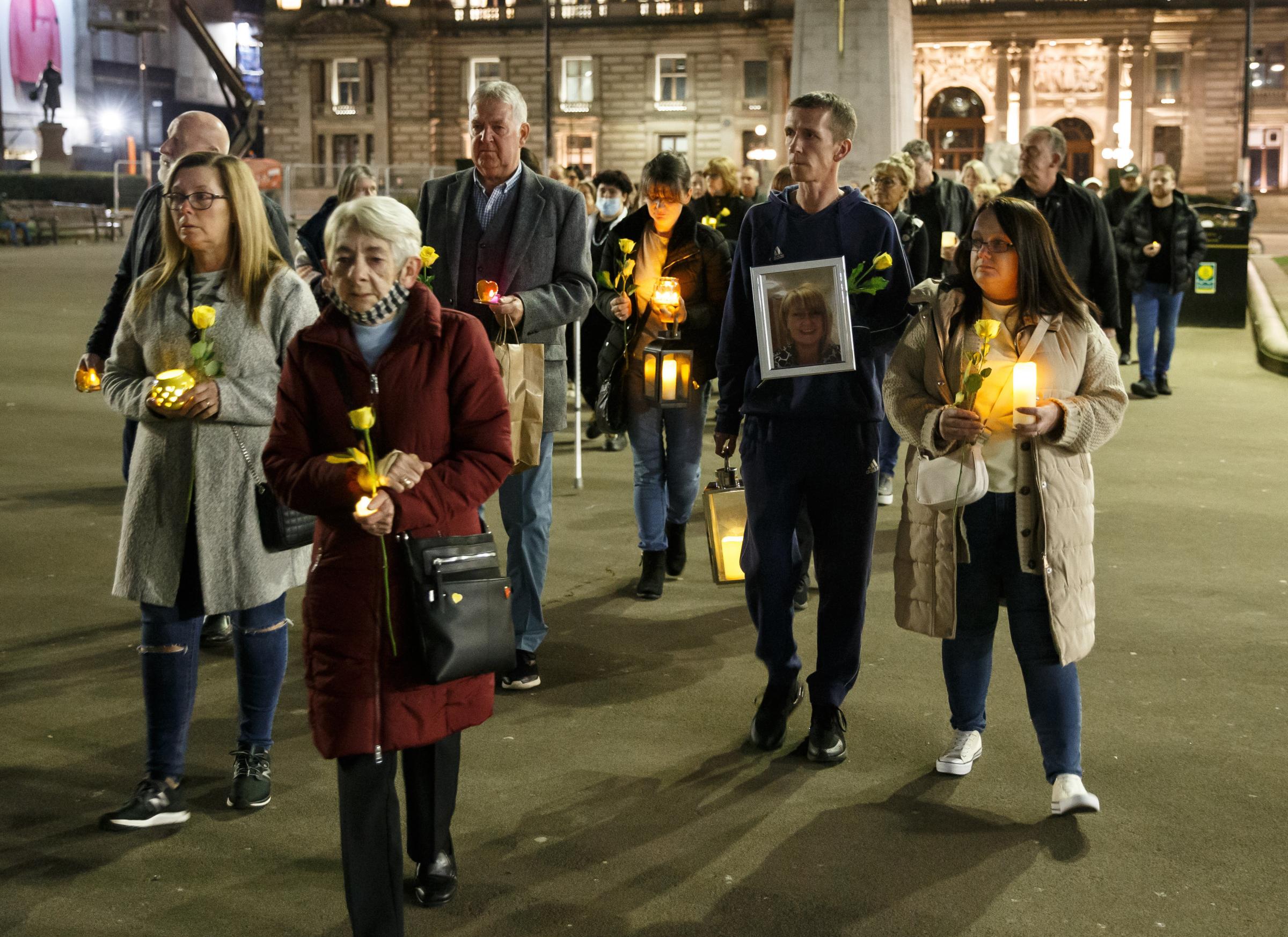 Vigil at George Square, Glasgow to mark the second national lockdown anniversary. The event attended by families who lost loved ones in the covid pandemic was organised by Covid 19 Families Scotland. Pictured are people walking into the square.