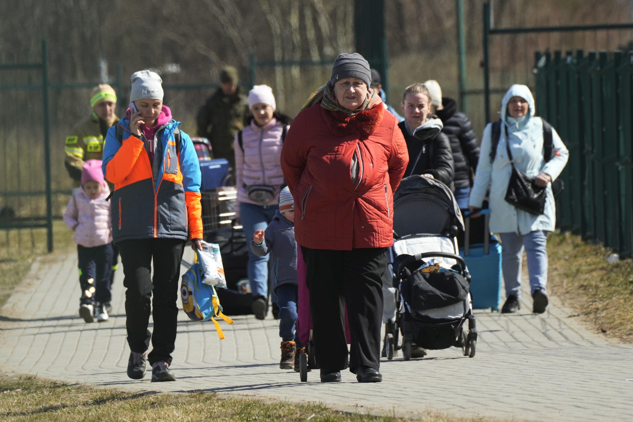 Refugees walk at the border crossing in Medyka, southeastern Poland, after fleeing the war from neighbouring Ukraine.