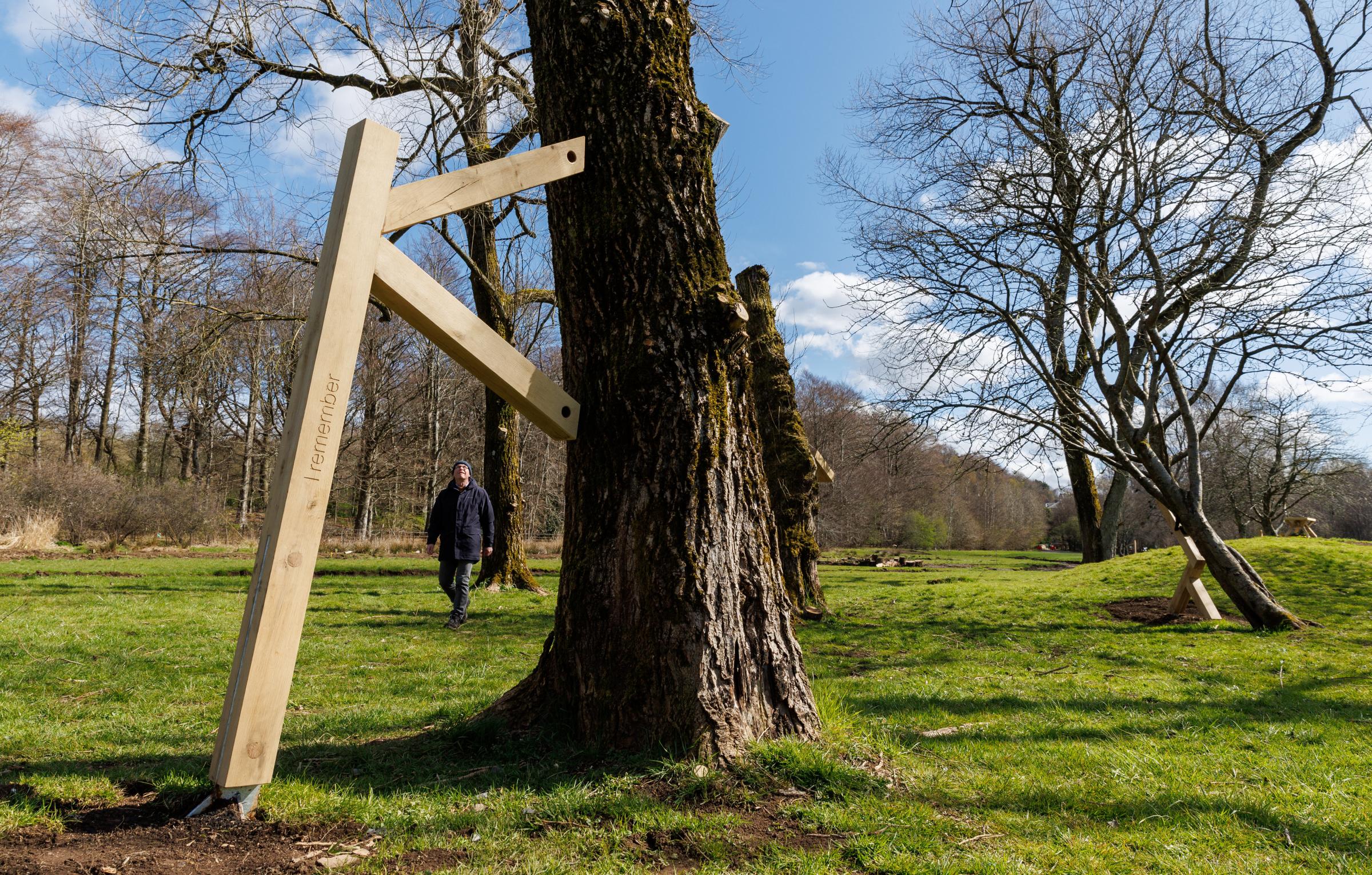 National Covid Memorial at Riverside Grove in Pollok Country Park. Pictured is Billy Boyce looking at the I Remember tree supports created by artist Alec Finlay that have started to be erected. Photograph by Colin Mearns.
