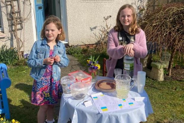 HeraldScotland: Christina and her little sister Hayley at their stall raising money for Newsquest's Ukraine appeal.