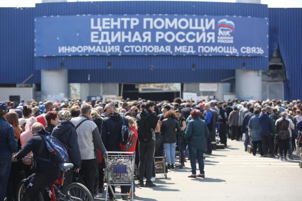 HeraldScotland: Civilians in Mariupol line up to receive humanitarian aid (Alexei Alexandrov/AP)