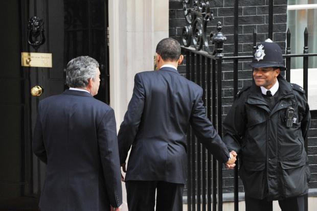 President Obama shakes the hand of the Downing Street police officer