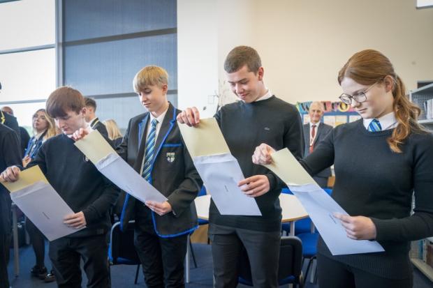 Students at Auchmuty High School in Glenrothes, Fife, open their exam results. Photo: PA