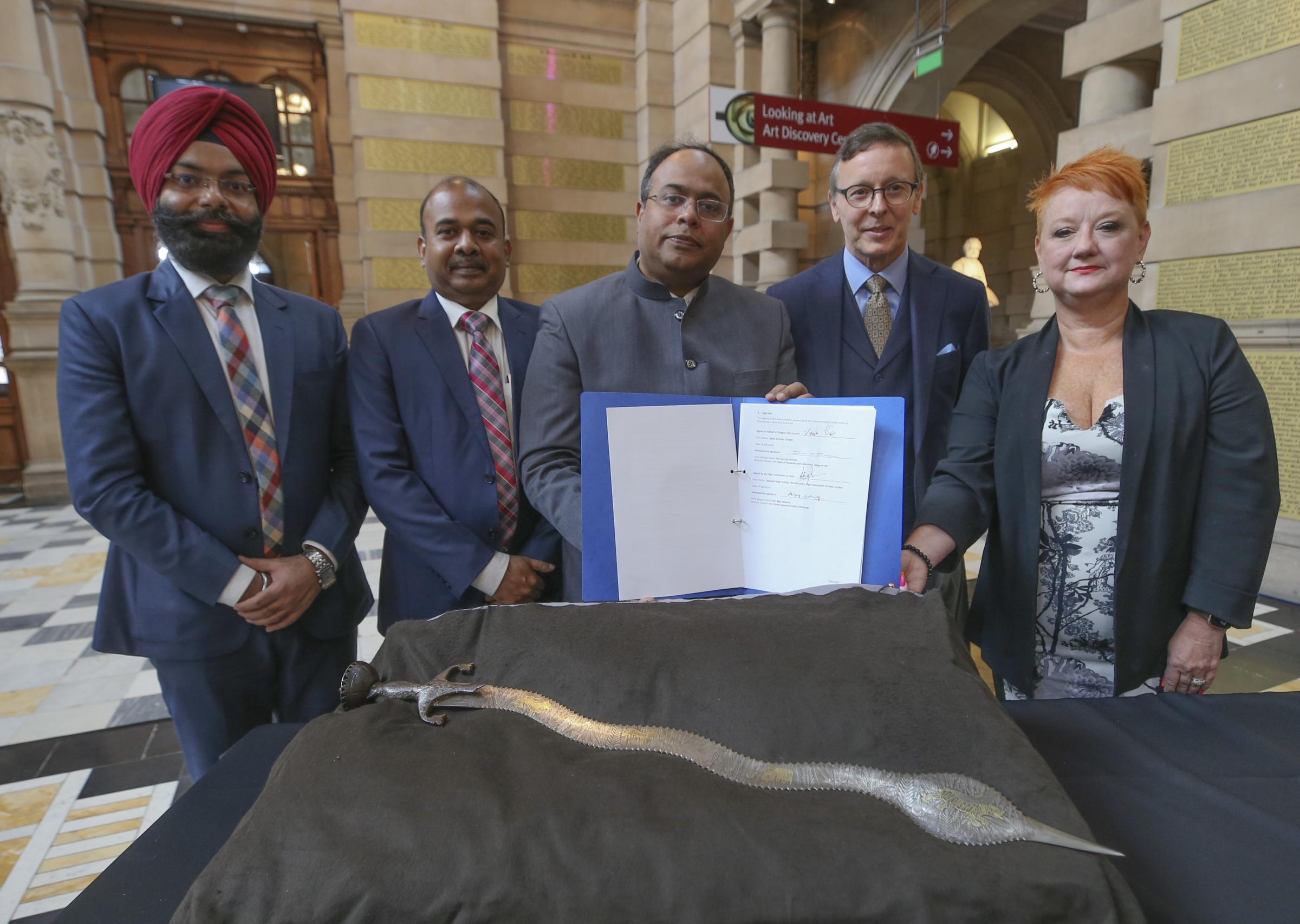 A signing ceremony at Kelvingrove Art Gallery. Left to right Jaspreet Sukhija, First Secretary High Commission of India, Vijay Selvaraj, Consul General of India, Sujit Ghosh acting high commissioner of India, Duncan Dornan Head of Museums and collections