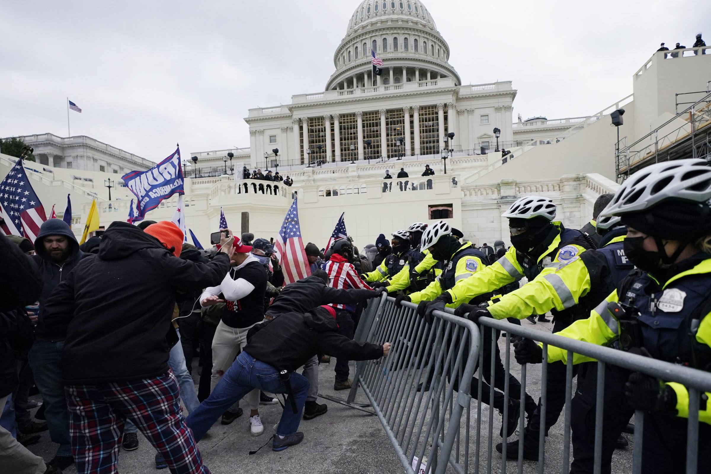 FILE - Insurrectionists loyal to President Donald Trump try to break through a police barrier, Wednesday, Jan. 6, 2021, at the Capitol in Washington. Facing prison time and dire personal consequences for storming the U.S. Capitol, some Jan. 6 defendants