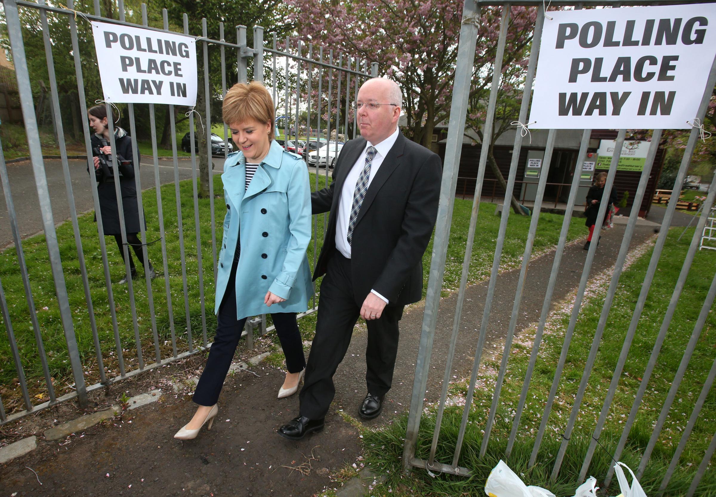 First Minister and SNP Leader Nicola Sturgeon and her husband Peter Murrell outside Broomhouse Community Hall polling station in Glasgow after casting their votes for the local council elections..