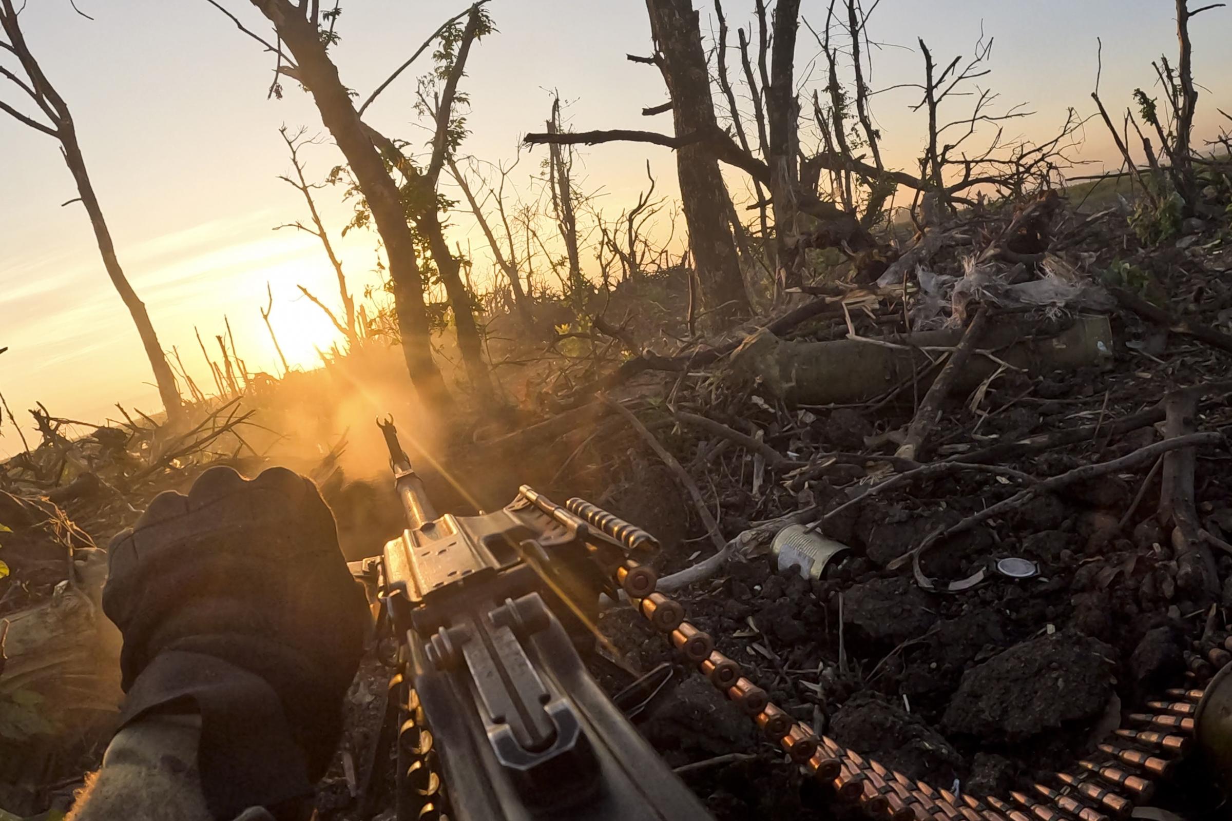 In this image taken from a video released by the 3rd Assault Brigade, a Ukrainian servicemen fires machine gun towards Russian positions near Andriivka, Donetsk region, Ukraine, Aug. 27, 2023. Ukrainian brigades two-month battle to fight its way