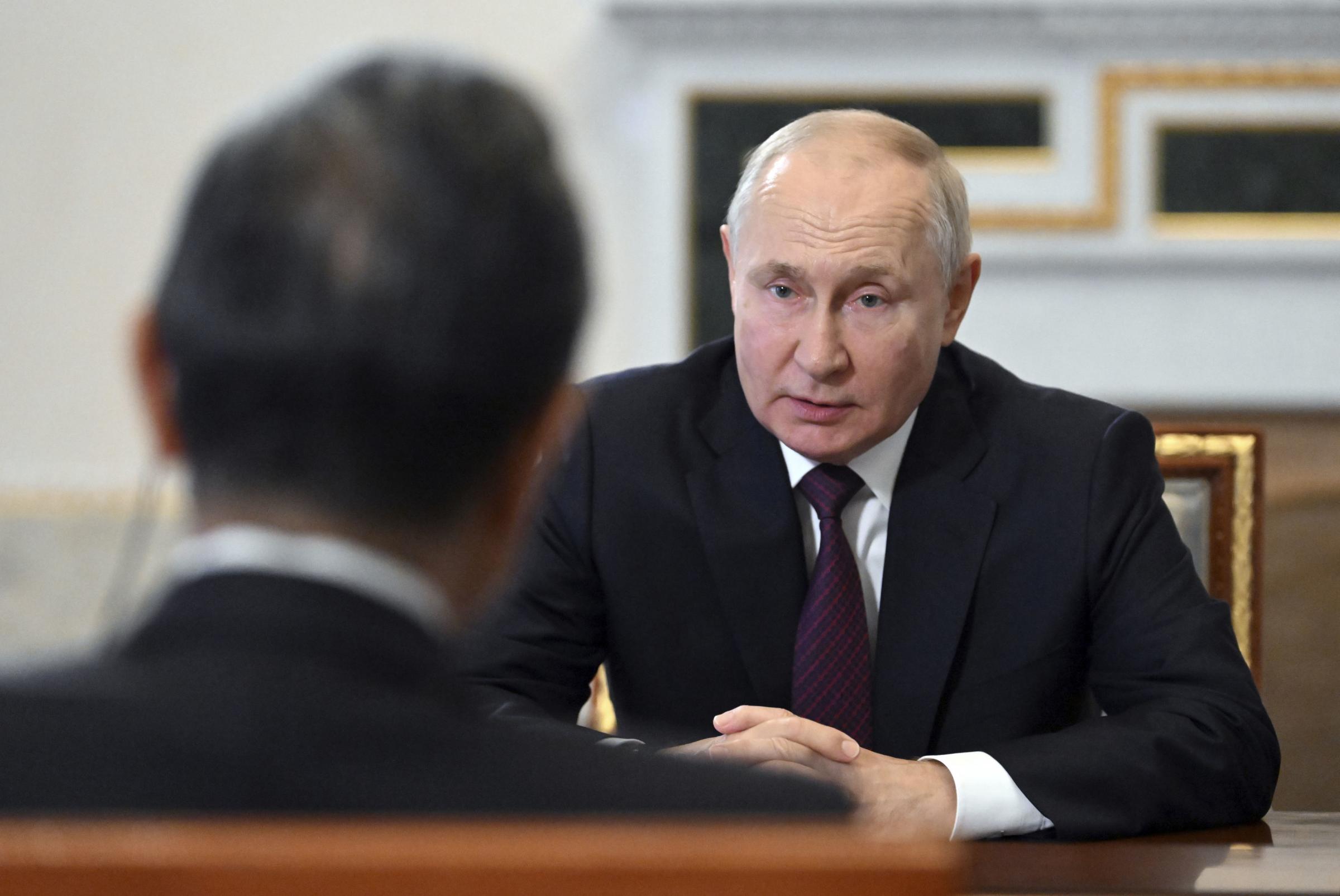Russian President Vladimir Putin speaks with Chinese Foreign Minister Wang Yi, left, on the occasion of their meeting at the Constantine Palace in St. Petersburg, Russia, Wednesday, Sept. 20, 2023. (Kristina Kormilitsyna, Sputnik, Kremlin Pool Photo via