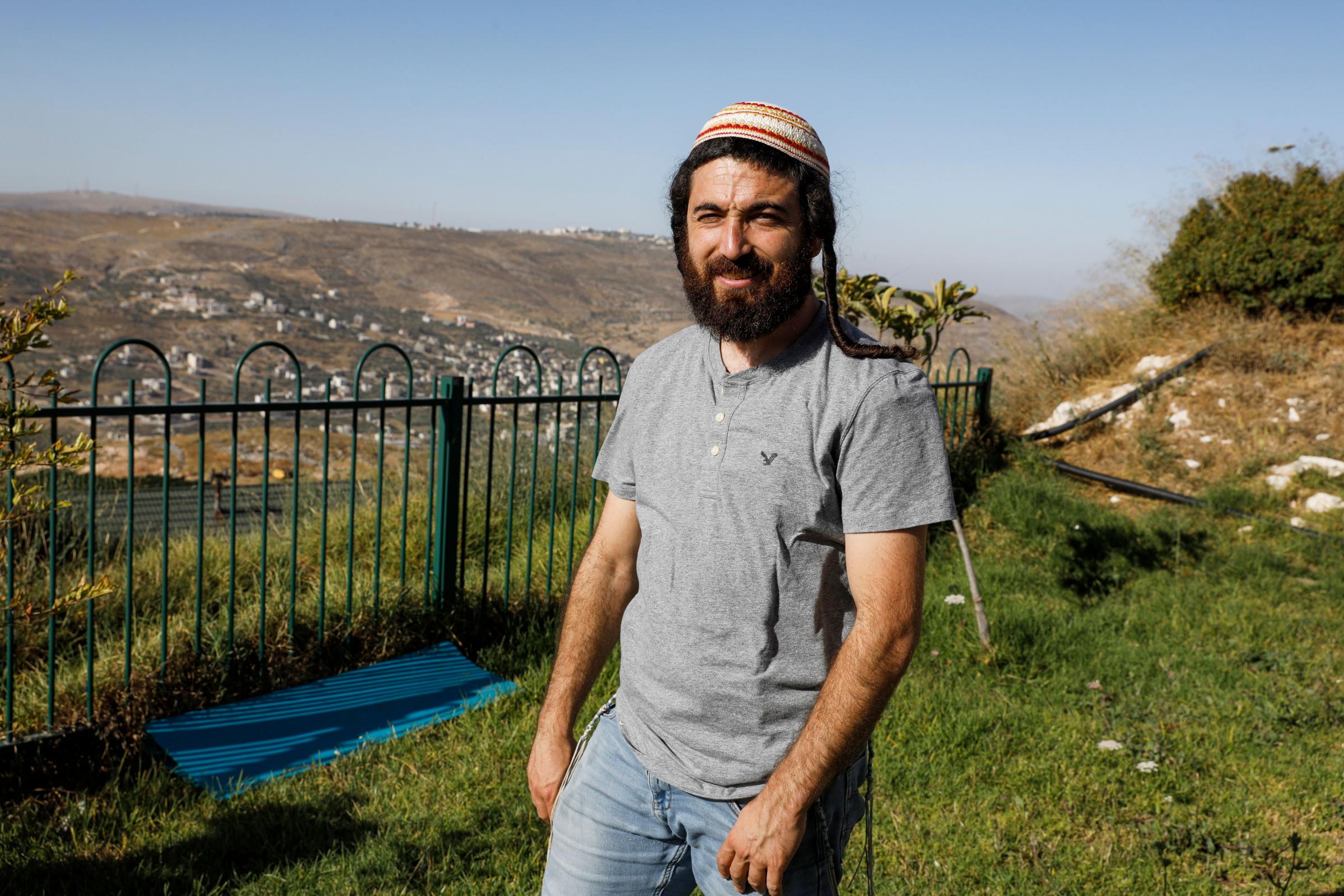 Tzvi Succot, the 29-year-old son of an ultra-Orthodox family, poses for a picture outside his home in the settlement of Yitzhar south of the Palestinian city of Nablus in the occupied West Bank, on June 22, 2020. - The 450,000 Israeli settlers in the
