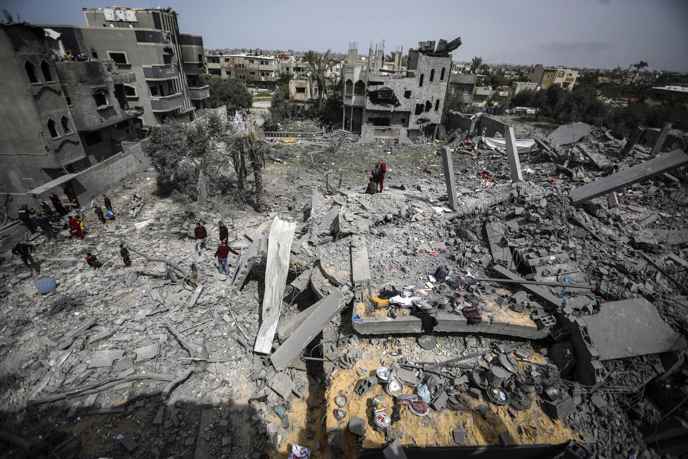 Palestinians inspect the damage to a residential building for the Moussa family after an Israeli airstrike in the Maghazi refugee camp, central Gaza Strip, Friday, March 29, 2024. (AP Photo/Ismael Abu Dayyah) 