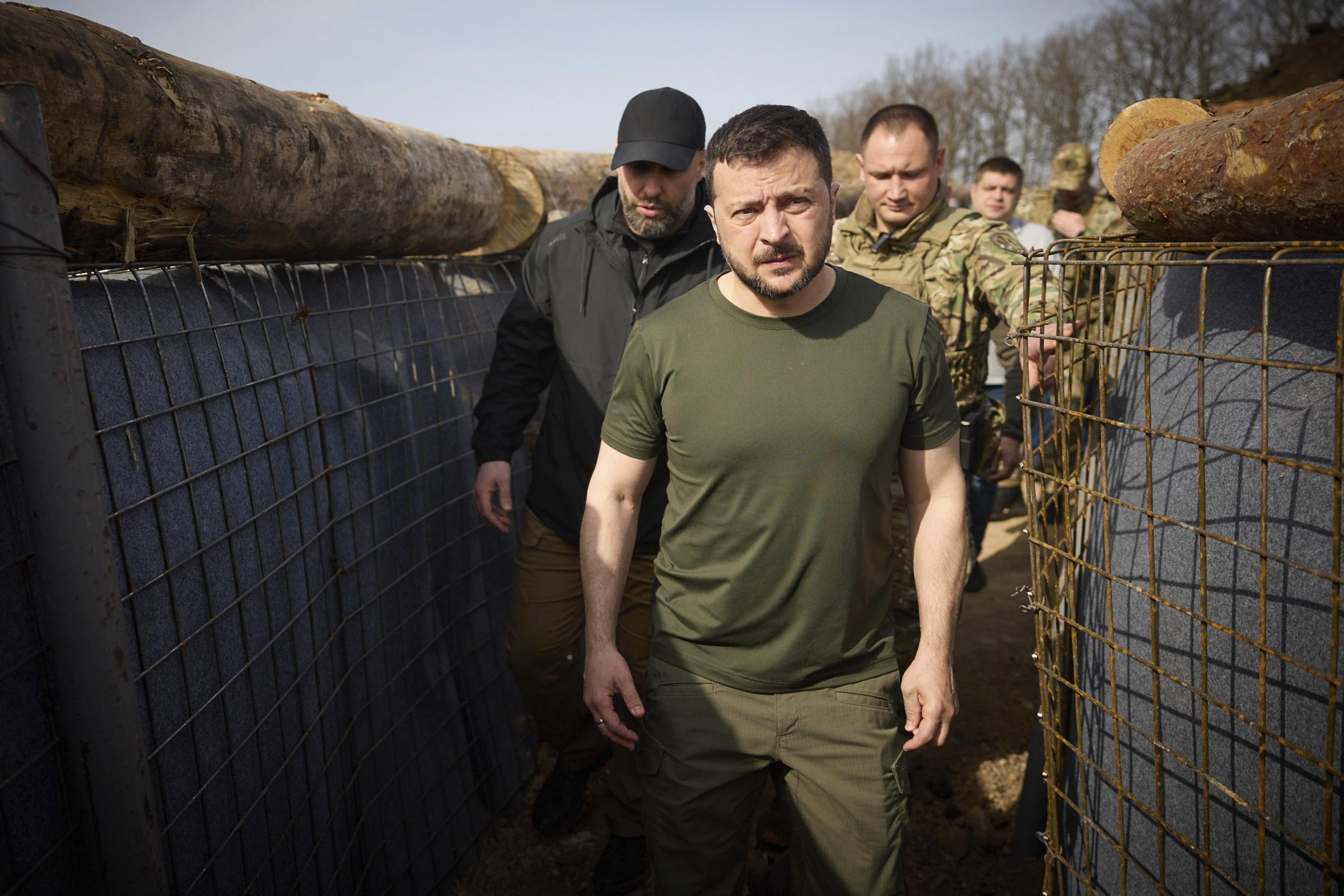 In this photo provided by the Ukrainian Presidential Press Office, Ukrainian President Volodymyr Zelenskyy inspects the fortification lines in Kharkiv region, Ukraine, Tuesday, April 9, 2024. (Ukrainian Presidential Press Office via AP).