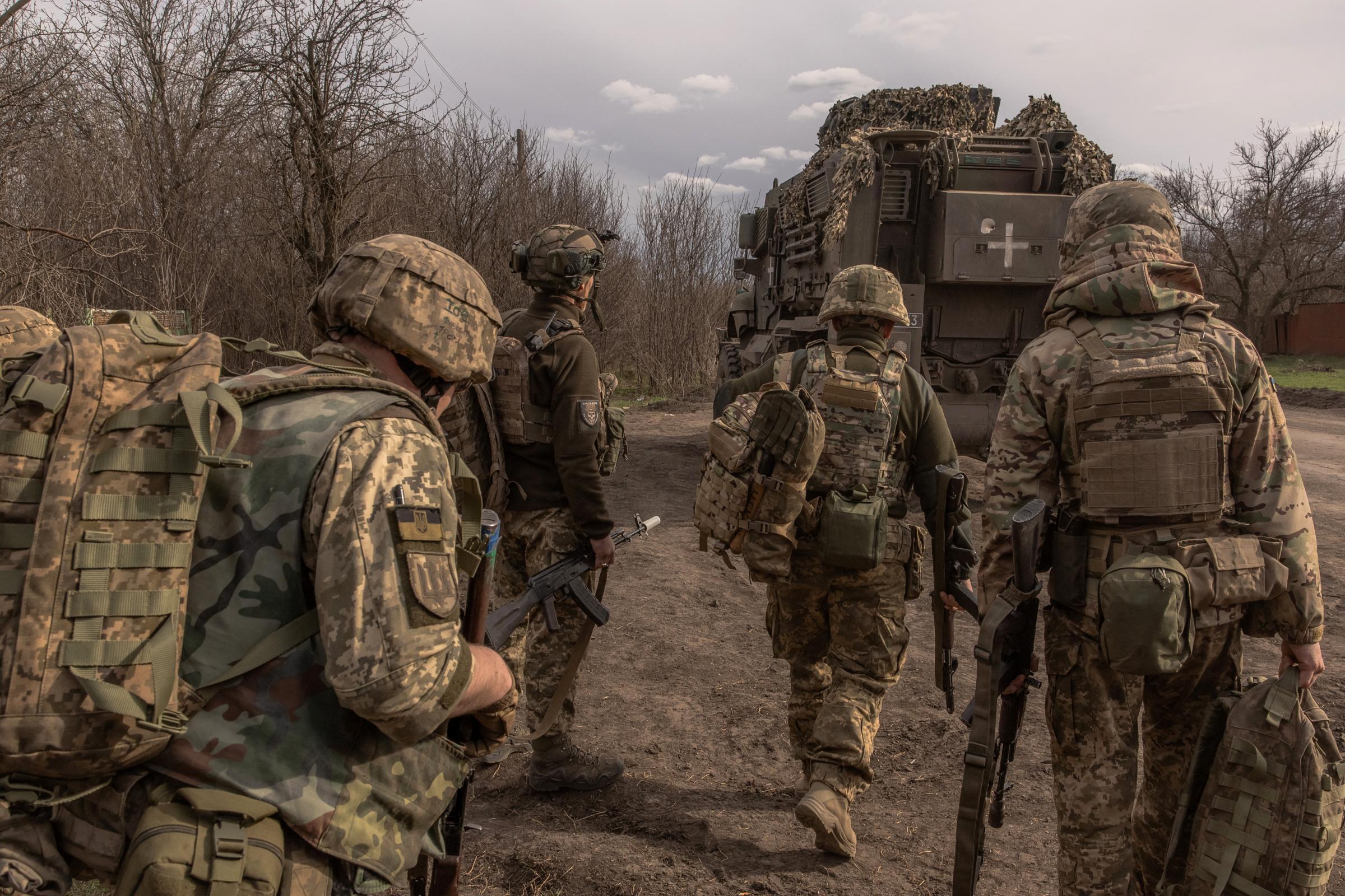 Ukrainian infantry soldiers of the 23rd Mechanized Brigade walk to board an armored fighting vehicle MaxxPro to head toward the frontline in the Avdiivka direction, in the Donetsk region, on April 3, 2024, amid the Russian invasion of Ukraine. (Photo by