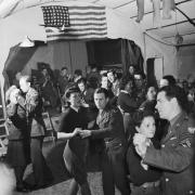 British Land Army girls and members of the Women's Royal Air Force (WAAF) dance with men of the US Eighth Army Air Force in Suffolk