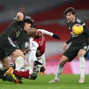 Harry Maguire is booked for challenge on Alexandre Lacazette