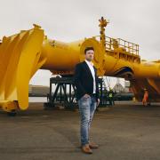 Mocean Energy managing director Cameron McNatt  with the company's Blue X wave energy converter at Forth Ports’ Rosyth Docks