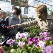 Nicola Sturgeon meets a young child during a visit to Rouken Glen Garden Centre in Giffnock