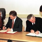 The then Prime Minister Tony Blair and the Irish Taoiseach Bertie Ahern sign the Good Friday Agreement in April 1998. The author is on the left, showing Mr Blair where to sign.
