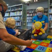 Glasgow Life assistant Gail Hughes, right, taking a Bookbug session at Gorbals library, Glasgow. Pictured joining in is Dylan Stewart, age 18 months, with his grandmother Marie Callaghan. Photograph by Colin Mearns.