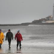 Dog walkers on the beach at Whitley Bay in North Tyneside before Storm Dudley hits the north of England/southern Scotland from Wednesday night into Thursday morning, closely followed by Storm Eunice on Friday. (PA)