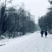 People walking in a snowy wintery scene. Credit: PA