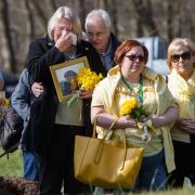 People pictured during a minute's silence for those lost to Covid at Riverside Grove in Pollok Country Park in Glasgow. Photograph by Colin Mearns.