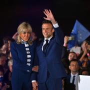 Emmanuel Macron and his wife Brigitte Macron acknowledge voters in front of the Eiffel Tower, Paris after after giving a speech after beating his far-right rival Marine Le Pen for a second five-year term as president. Photo Getty.