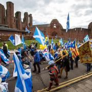 All Under One Banner march for independence, Arbroath. Marchers walk past Arbroath Abbey. 
 Photograph by Colin Mearns, Saturday 2 April 2022.