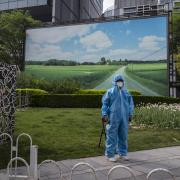 A security guard wears full PPE to protect against the spread of COVID-19 at a testing site in Chaoyang District on April 25, 2022 in Beijing, China.  (Photo by Kevin Frayer/Getty Images) *** BESTPIX ***.
