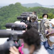 Visitors use binoculars to see the North Korean side from the unification observatory in Paju, South Korea, Thursday, May 12, 2022. North Korea imposed a nationwide lockdown Thursday to control its first acknowledged COVID-19 outbreak after holding for