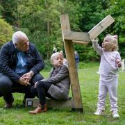 Covid Memorial: Peter McMahon pictured with his grandchildren, Bella and Brodie, next to one of the supports created by artist Alec Finlay.