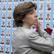 French Foreign Minister Catherine Colonna visits the Memorial Wall of Fallen Defenders of Ukraine in Kyiv, Ukraine, Monday, May 30, 2022. (AP Photo/Natacha Pisarenko)