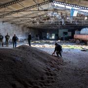 NOVOVORONTSOVKA, UKRAINE - MAY 06: Local government officials and  Ukrainian soldiers inspect a wheat grain warehouse earlier shelled by Russian forces on May 06, 2022 near the frontlines of Kherson Oblast in Novovorontsovka, Ukraine. Russia has been